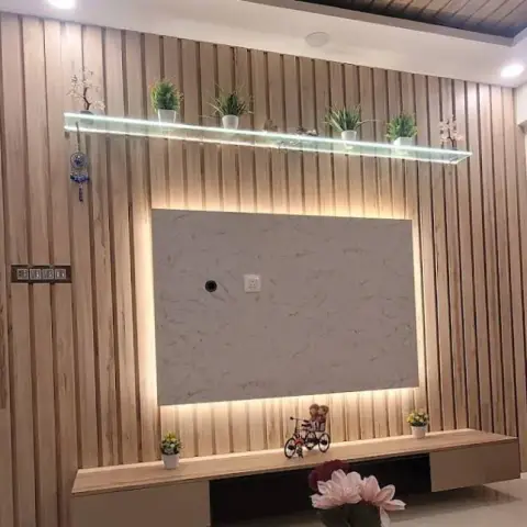 Living room feature wall of full-height oak fluted battens with a backlit white marble-look TV panel