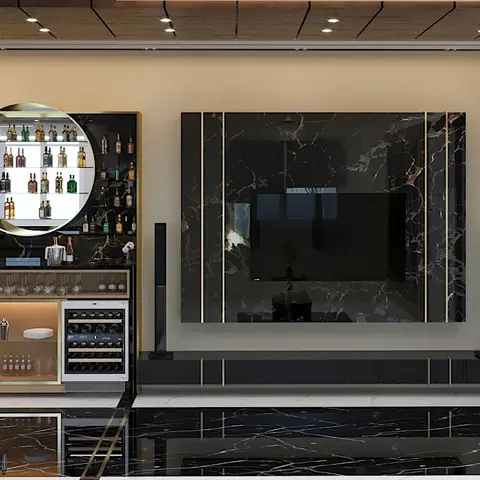 Living room feature wall with a book-matched black-marble TV panel and gold trim beside a mirrored home bar unit with a wine cooler and a jaali-screen door.