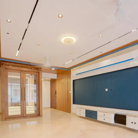 Living room feature wall with a teal fluted panel behind a floating marble-top TV console