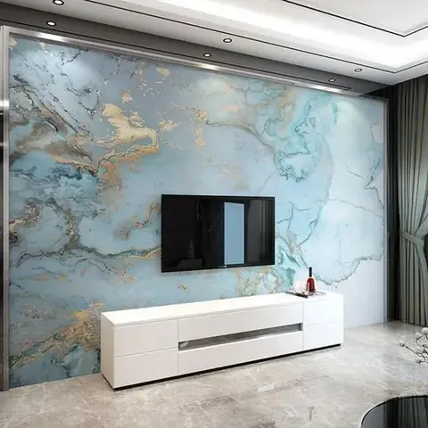 Living room feature wall with a dramatic teal-and-gold marble-pattern mural behind a wall-mounted TV and white gloss console.