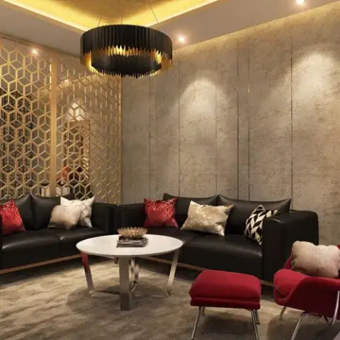 Living room render where a gold hexagonal jaali screen shields the entry door beside a black leather L-sofa