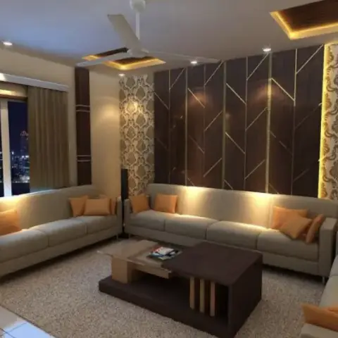 Living room render with an L-shaped grey sectional facing a gold-inlaid dark-wood chevron panel wall flanked by damask wallpaper