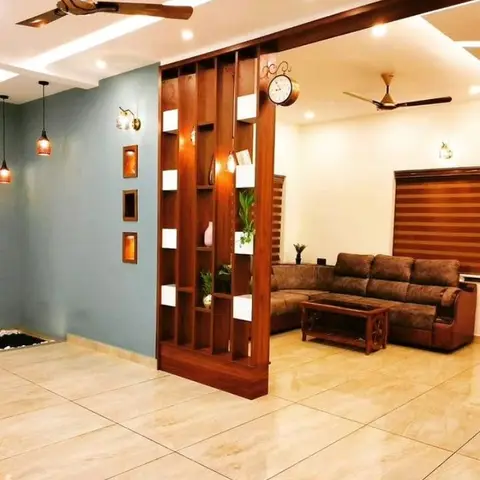 Living room separated from the entrance by a wood slat partition with display niches