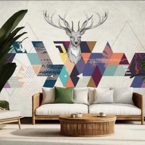 Living room styled with a rattan sofa and armchair around a woven coffee table, set against a geometric mosaic wallpaper mural featuring an illustrated stag.
