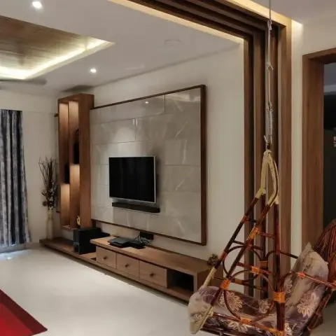 Living room TV feature wall framed in wood battens around a marble-look tile panel