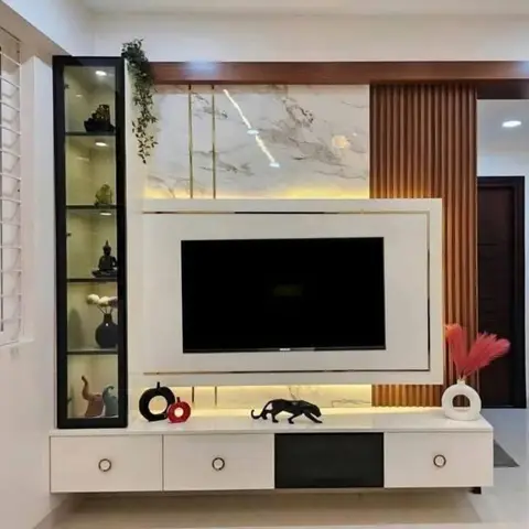 Living room TV feature wall with a marble-clad panel framed in brass strips, fluted wood side panelling, a backlit white TV console with gold trim