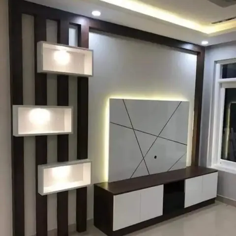 Living room TV feature wall with a backlit angular-line panel flanked by dark wood strip panelling and floating lit display niches.