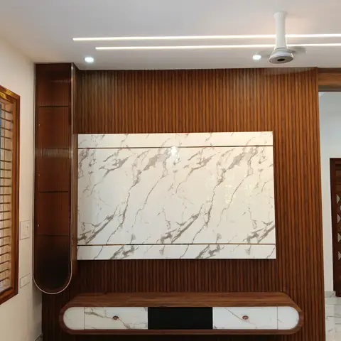 Living room TV feature wall with vertical fluted wood panelling, a bookmatched white marble slab panel