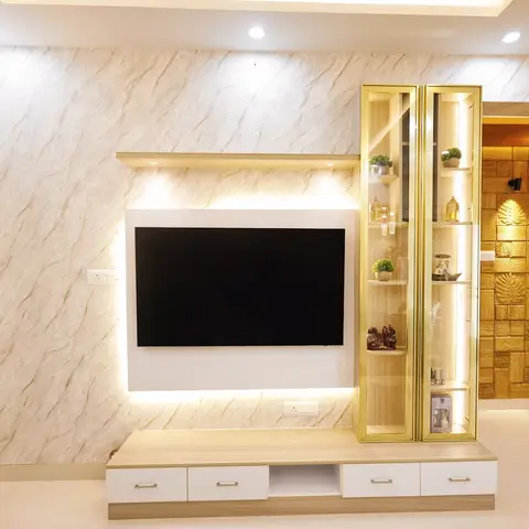 Living room TV feature wall with marble-effect cladding, a backlit floating shelf and a gold-framed display cabinet