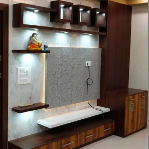 Living room TV feature wall with marble-effect cladding, backlit wood display cubbies holding a small idol, and a floating wood-laminate media console.