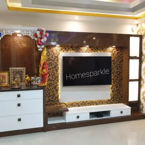 Living room TV feature wall with a gold triangle-mosaic accent panel, white console with drawers