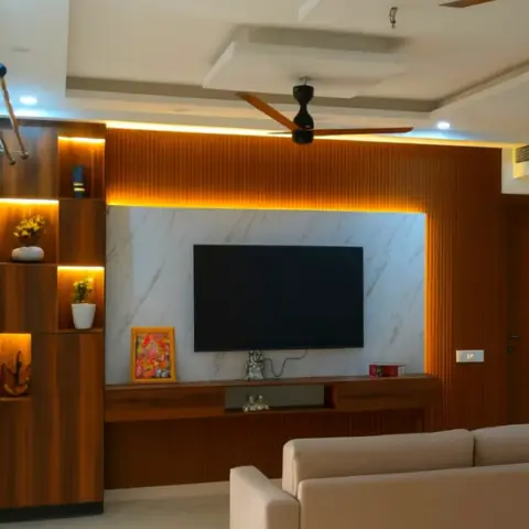 Living room TV feature wall with a backlit white marble panel framed by warm wood fluted panelling, layered pop ceiling with cove lighting