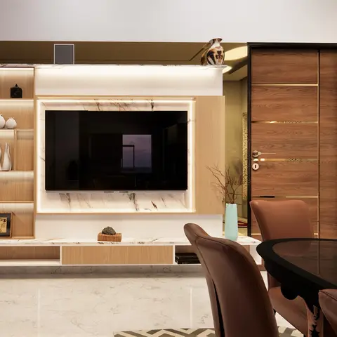 Living room TV unit wall with a book-matched marble backdrop, floating wood console, and open display shelving styled with ceramic vases