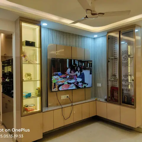 Living room TV unit with backlit display shelving, a fluted panel accent wall and an integrated glass-fronted pooja niche.