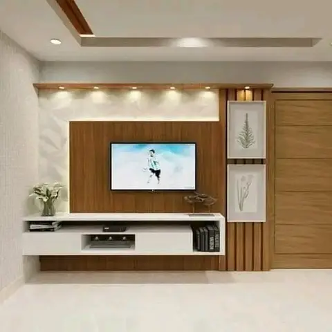 Living room TV wall combining a marble-and-wood panel with a stone-clad accent wall, a floating white-and-wood TV console and framed botanical prints.