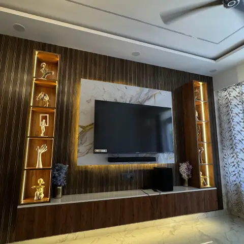 Living room TV wall in dark walnut fluted panelling running the full width, with a white-and-gold veined slab behind the TV and soundbar