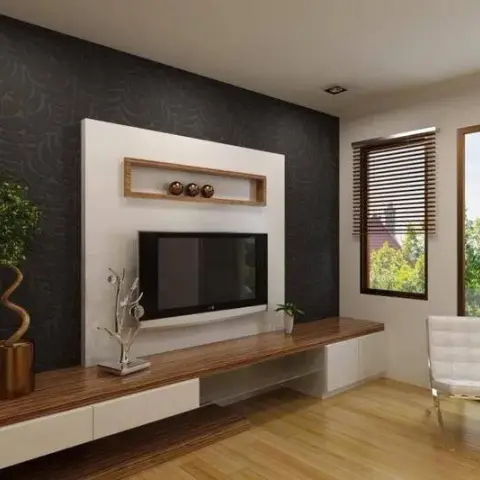 Living room TV wall in dark textured wallpaper with a white recessed display niche, paired with a wood floating console and a white leather lounge chair.