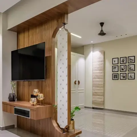 Living room TV wall in walnut veneer with a floating console styled with glass decanters, an arched wallpaper-clad divider column