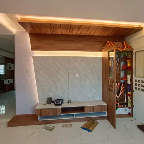 Living room TV wall in wood cove-lit panelling and marble-look cladding with a floating wood console