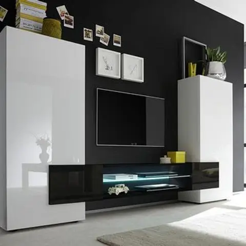 Living room TV wall unit in white gloss and black laminate with a blue LED strip accent, set against a black feature wall with pinned photo frames.