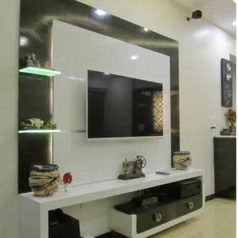 Living room TV wall unit in glossy black-and-white high-gloss finish with LED-lit glass display shelves and a rounded-corner console below.