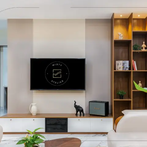 Living room TV wall where a wall-hung white-and-teak console with brass knobs runs under a screen on a beige panel band