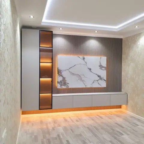 Living room TV wall with a fluted wood panel backdrop, a backlit marble slab inset, and a floating console with a glowing under-plinth