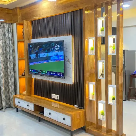 Living room TV wall with a warm wood-veneer surround around a black fluted panel and marble insert, a floating console with marble-pattern drawer fronts