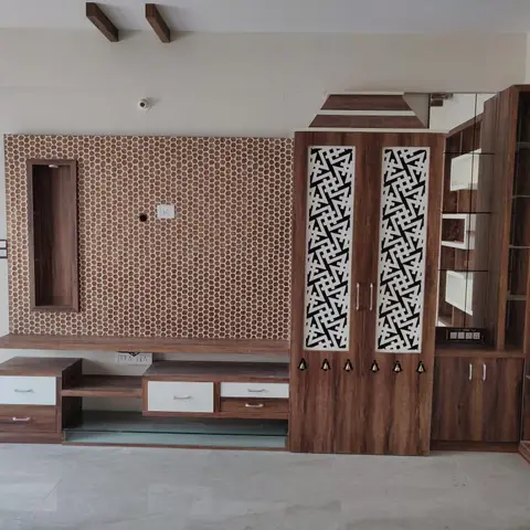 Living room TV wall with a copper hexagon mosaic accent panel, a low wood TV console with white-fronted drawers