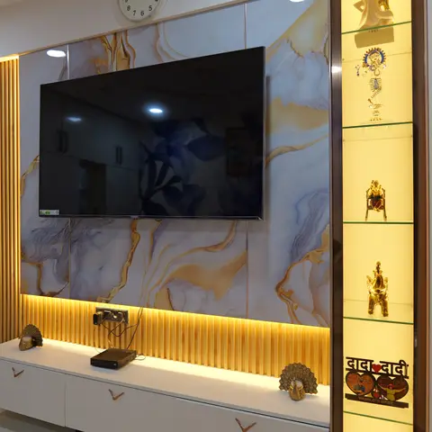 Living room TV wall with a backlit onyx-marble panel, gold fluted trim, a floating white TV console with rose-gold handles