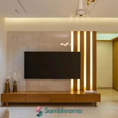 Living room TV wall with a large stone slab panel backdrop, a wood veneer console with tapered legs