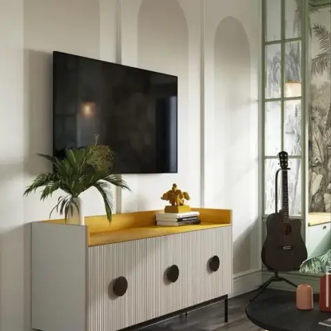 Living room TV wall with arched panel mouldings, a mustard-yellow-topped fluted TV console with disc pulls