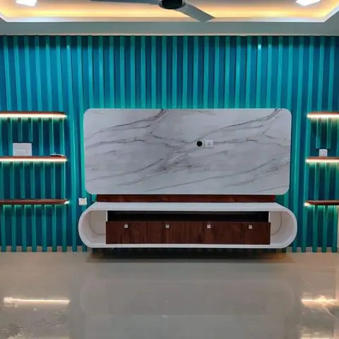 Living room TV wall with bold teal fluted panelling, a marble slab backdrop, a rounded floating TV console in walnut and white