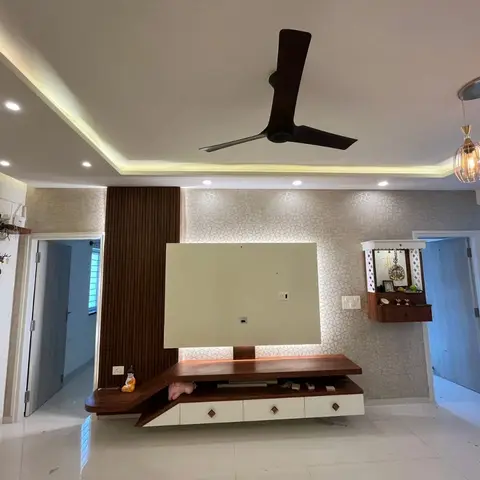 Living room TV wall with geometric wallpaper and a fluted wood accent strip, an asymmetric floating wood-and-white console