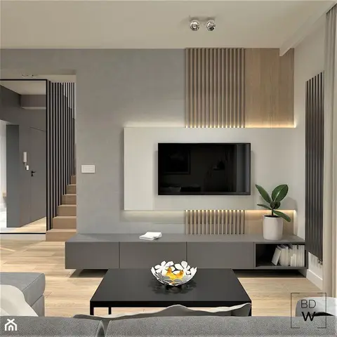Living room TV wall with vertical fluted wood slats backlit around a wall-mounted screen, over a floating grey console.