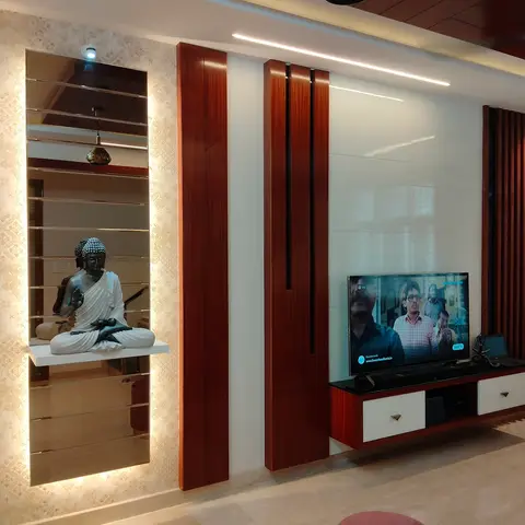Living room TV wall with vertical wood-fin panelling and a floating console beside a backlit mirrored wallpaper niche displaying a Buddha statue.