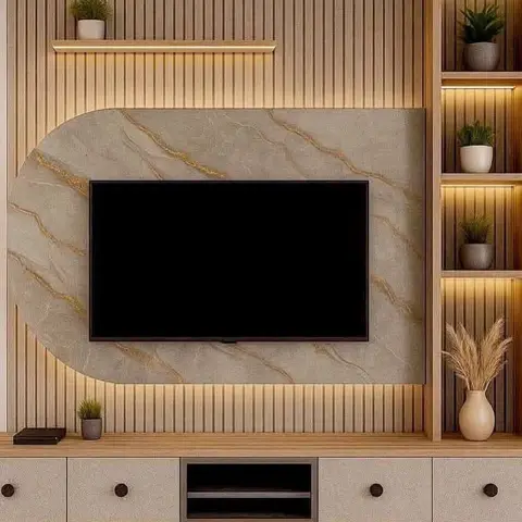 Living room TV wall with vertical fluted wood panelling, an arched gold-veined marble-effect backdrop and backlit display niches styled with potted plants.