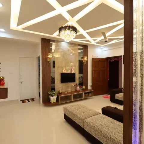 Living room under a POP ceiling cut with crisscrossing lit strips, a crystal-and-black chandelier over zebra-print sofas