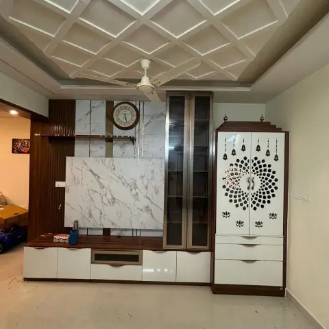 Living room wall running from a teak fluted panel and a Statuario-look TV backing with a round wall clock, through a fluted-glass tall crockery unit
