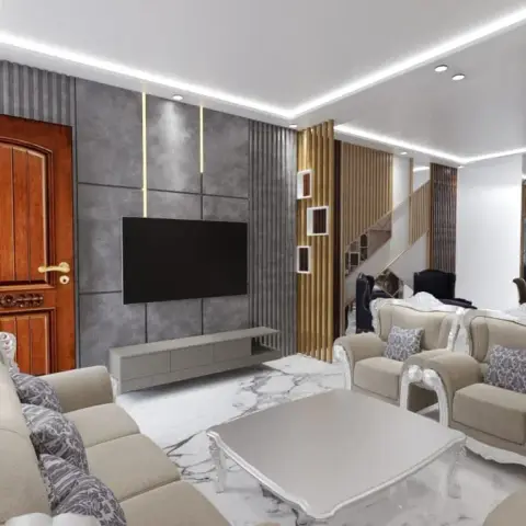 Living room where a carved white-lacquer sofa set in beige faces a grey concrete-finish TV wall gridded with brass reveals