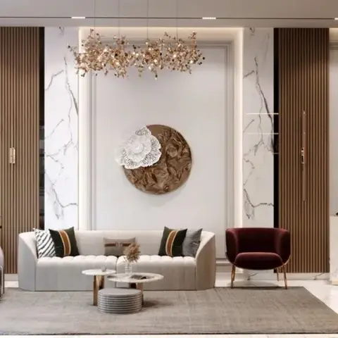 Living room where a channel-tufted cream curved sofa sits under a large gilt-and-white floral wall sculpture