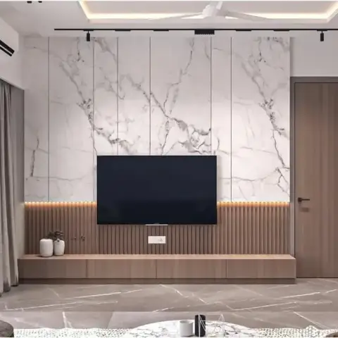 Living room where a white marble slab TV wall sits over a fluted wood band with a warm LED strip, above a long floating console