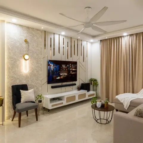 Living room with a backlit fluted wall panel and floral wallpaper accent, a brass-trimmed TV console with rattan fronts