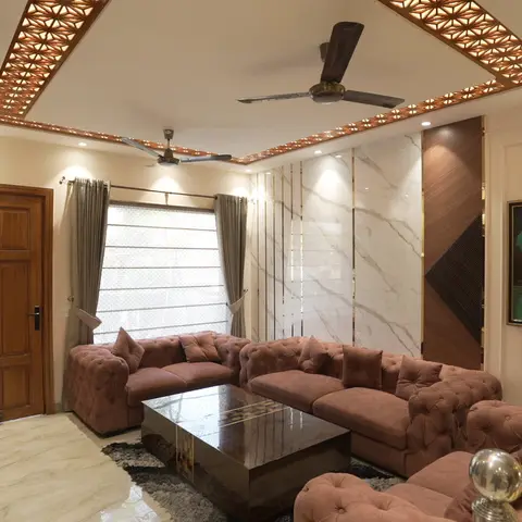 Living room with a backlit star-pattern cutwork false ceiling, a marble-and-wood feature wall with brass inlay strips