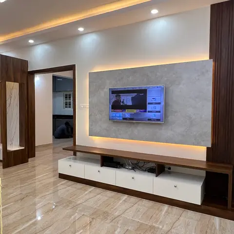 Living room with a backlit stone-effect TV feature wall bordered by dark wood fluted panelling, a floating wood-and-white TV console