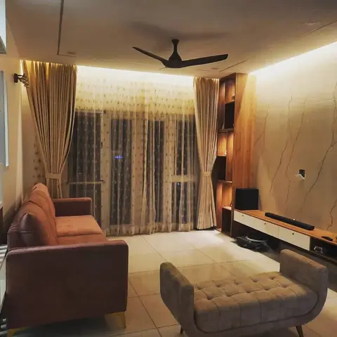 Living room with a backlit veined-marble feature wall behind an open wood TV console, rust velvet sofa