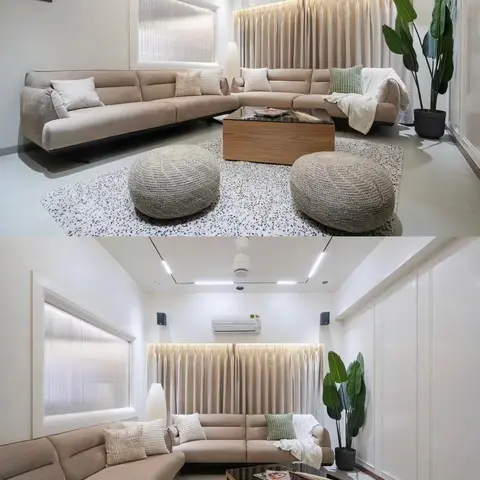 Living room with a beige sectional sofa, woven ottoman poufs, a wood-and-glass coffee table on a speckled terrazzo rug