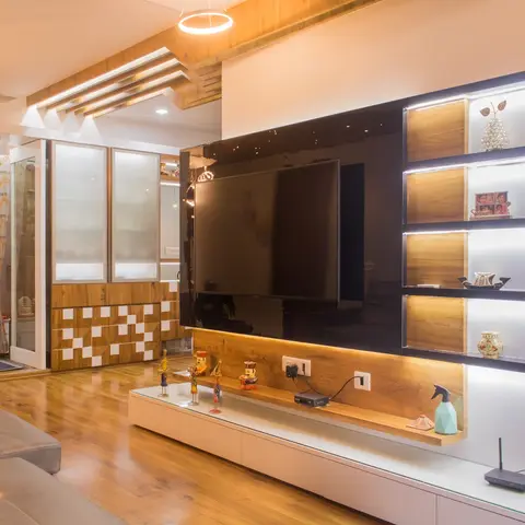 Living room with a black gloss TV wall panel, backlit wood-and-white curio display shelving, wood-strip false ceiling