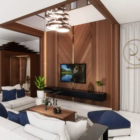 Living room with a book-matched wood-and-brass TV feature wall, a floating black console and a white sectional sofa with navy accent cushions