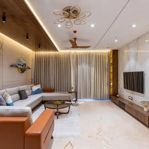 Living room with a book-matched marble TV wall, a wood-strip cove ceiling detail and a ring-shaped chandelier